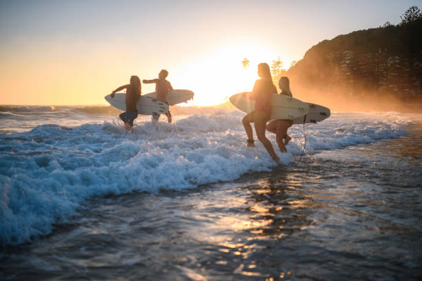 istock Gold Coast Surfers Running into Water with Boards at Dawn 1316390064