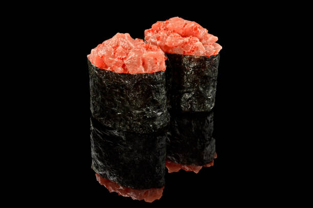 istock Spicy gunkan maki with salmon on black background 1316390115