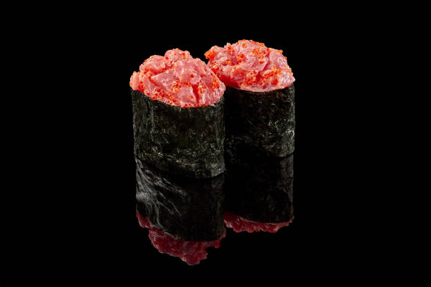 istock Spicy gunkan maki with raw tuna on black background 1316390134