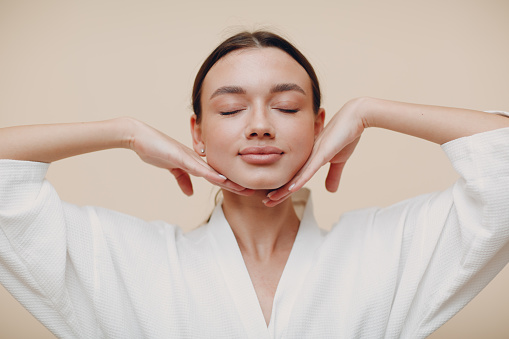 istock Young woman doing face building facial gymnastics self massage and rejuvenating exercises 1316390190