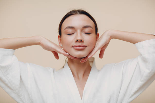 Young woman doing face building facial gymnastics self massage and rejuvenating exercises Young woman doing face building facial gymnastics self massage beauty stock pictures, royalty-free photos & images