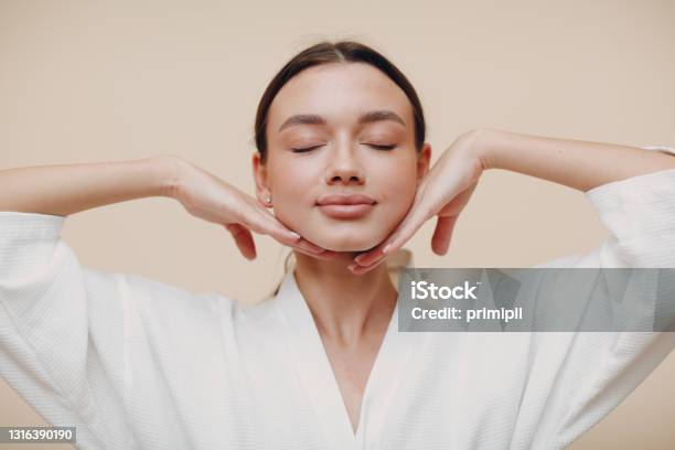 Young Woman Doing Face Building Facial Gymnastics Self Massage And Rejuvenating Exercises Stock Photo - Download Image Now
