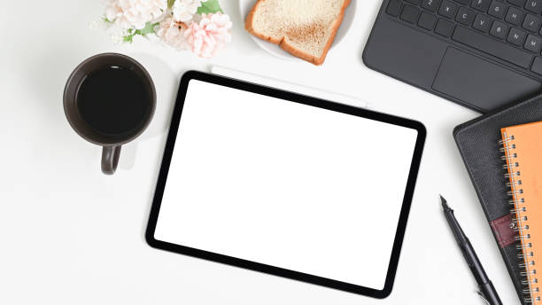 istock White office desk with digital tablet, notebook, bread and coffee cup. 1316391105
