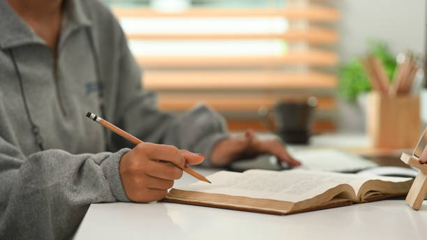 istock Cropped shot of college student writing information on notebook. 1316391296