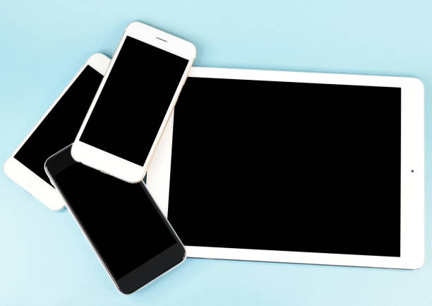 istock Tablet computer together with three smartphones stacked on the table 1316393373