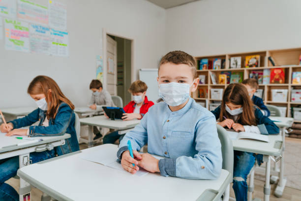 istock Elementary school students studying in the classroom during COVID-19 pandemic. 1316395285