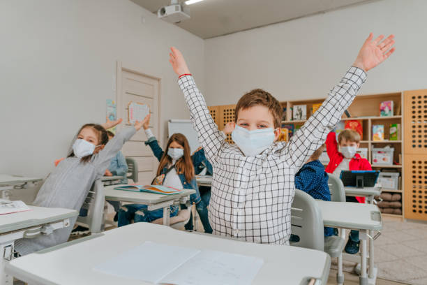 istock Elementary school students studying in the classroom during COVID-19 pandemic. 1316395342