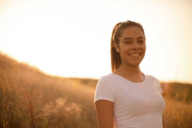 istock Young woman standing outside on a sunny day. 1316395360