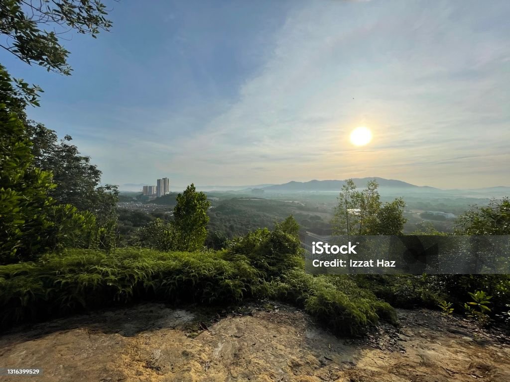 A scene one morning at the top of a hill showing the sun rising Beauty In Nature Stock Photo