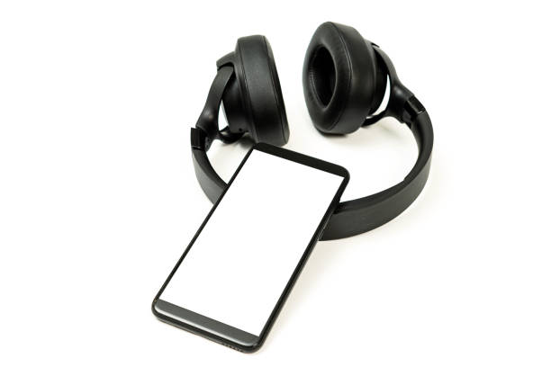 istock headphones with Bluetooth technology on white background, with black phone paired for music lovers 1316399607