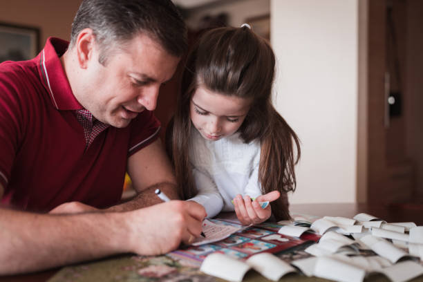 istock Father and daughter marking which stickers did they get 1316399698
