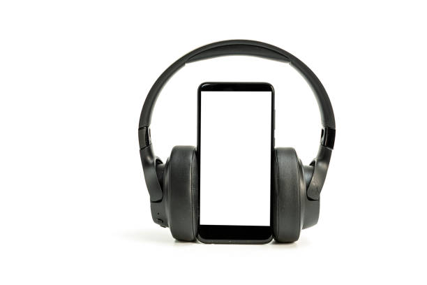 istock headphones with Bluetooth technology on white background, with black phone paired for music lovers 1316399743