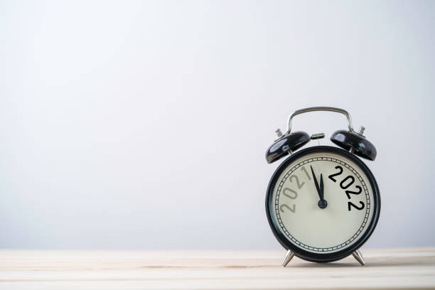 istock 2021 and 2022 on black alarm clock on wooden table with copy space , Merry Christmas and Happy new year concept. 1316403473
