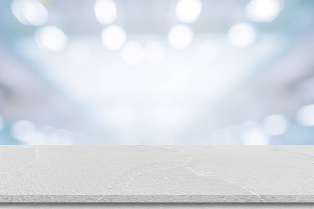 istock abstract blur inside office with modern perspective white cement table for show ads or promote product and content on display concept 1316403483
