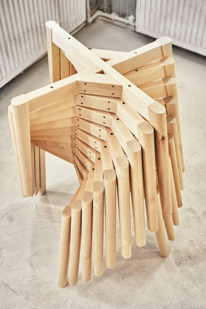 Pile of old stacked wooden deck chairs at the beach