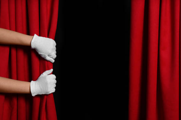 istock Woman opening red front curtains on black background, closeup. Space for text 1316403947