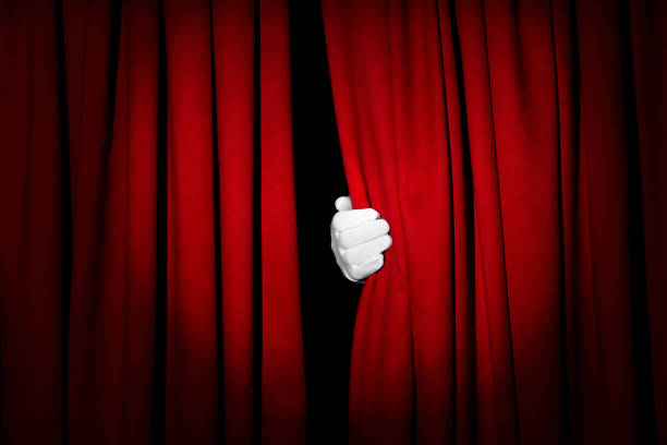 istock Person opening red front curtains on black background, closeup 1316403972