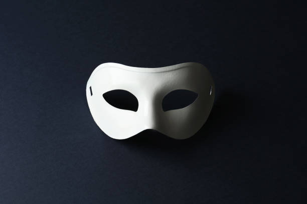 istock White theatre mask on black background, top view 1316404606