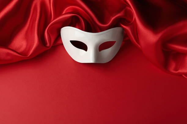 istock White theatre mask and fabric on red background, above view. Space for text 1316404994
