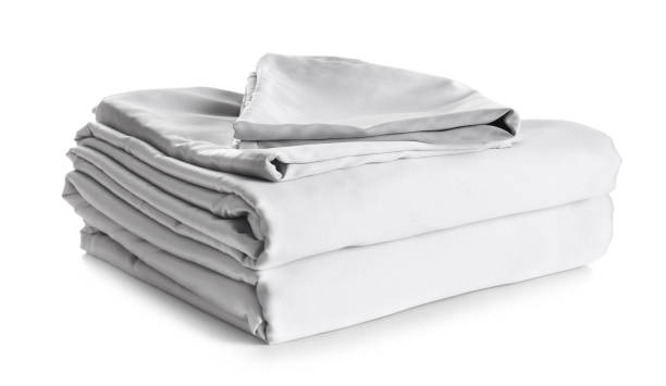 istock Stack of clean silky bed linen isolated on white 1316405198