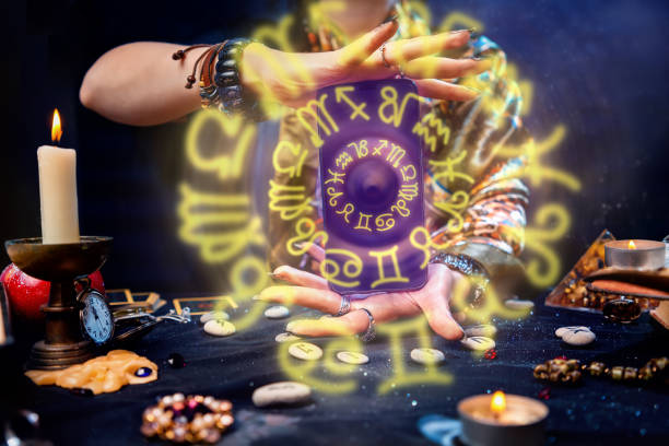 istock A fortune teller holds a smartphone in her hands, from which luminous zodiac circles fly out. Close-up. The concept of astrology, magic and esotericism 1316408862
