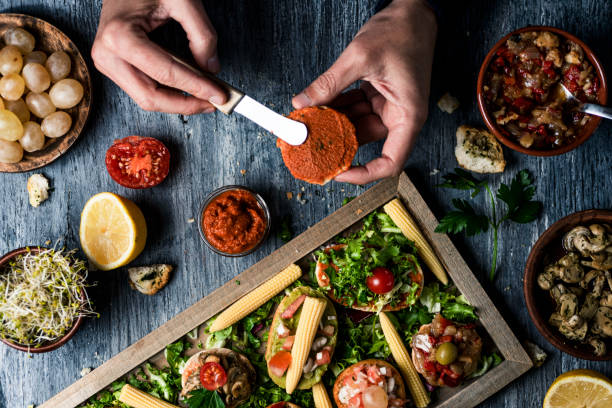 istock man spreading a vegan spread on halved toasted bun 1316409838