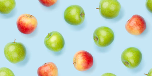 istock Green and red apple fruits over blue seamless 1316411919
