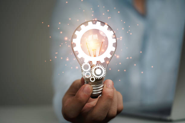 istock Businessman holding glowing lightbulb with mechanical gear , Creative thinking ideas and innovation concept. 1316412610