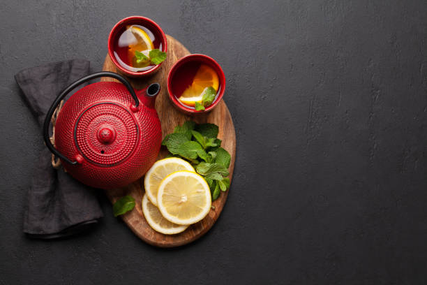 istock Herbal tea with mint and lemon. Tea cup and teapot 1316413246