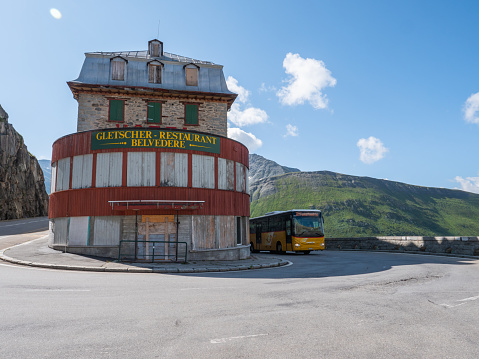 07/23/2020 : Furka pass, Valais canton, Switzerland\nLow angle vie won the curve, yellow Post bus moving up.