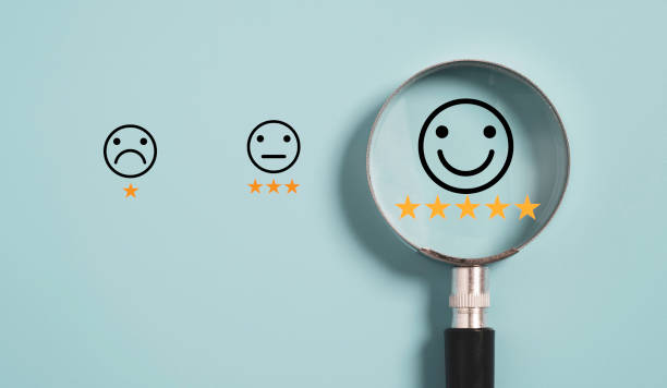 Smiley icon with five star inside magnifier glass on blue background ,