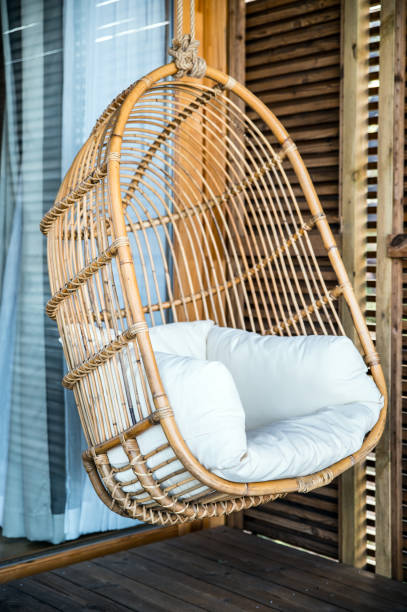 istock Hanging wicker chair with cushion 1316414372