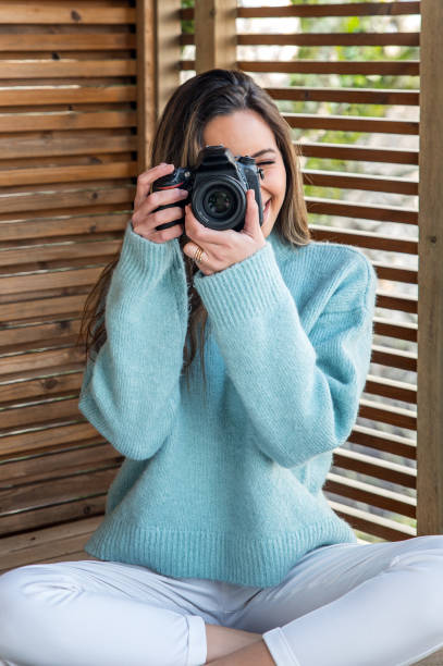 istock Young woman taking photo with camera from terrace 1316415405