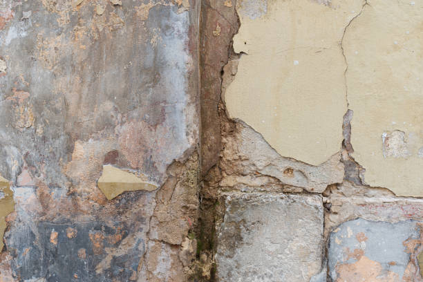 istock Aged plaster falls apart from an old castle wall 1316415783
