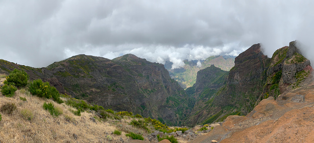 View over the mountains on Madeira island at the Ninho da Manta, or Eagle’s Nest close to the Pico do Arieiro on the Vereda do Areeiro - Pico Ruivo, a populair walkway over the highest mountains of the island.