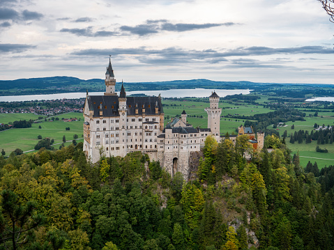 menthon saint bernard, france - 14 September 2022: a french medieval castle build on the slope of a mountain with a forest around