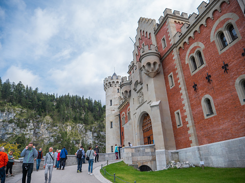 09/24/2020 Schwangau, Bavaria, Germany.\nTourists visiting Neuschwantein castle in Germany, front view