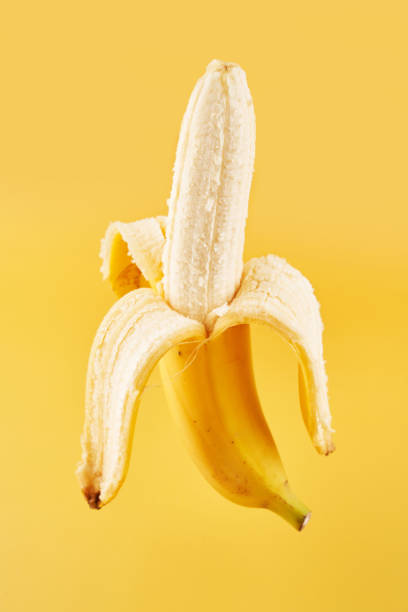 istock Whole banana with peel isolated on yellow background with copy space, clipping path 1316419562