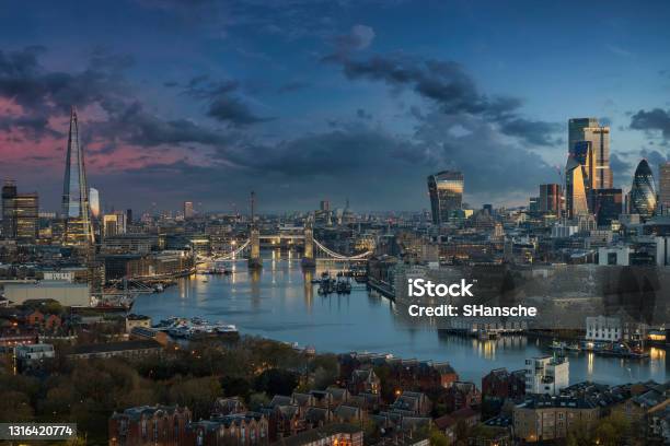 The Urban Skyline Of London Along The Thames River With Tower Bridge During Dawn Stock Photo - Download Image Now