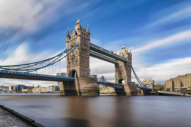 A low angle long exposure shot of the iconic Tower Bridge in London A low angle long exposure shot of the iconic Tower Bridge in London during a sunny day with cloudy sky bankside photos stock pictures, royalty-free photos & images