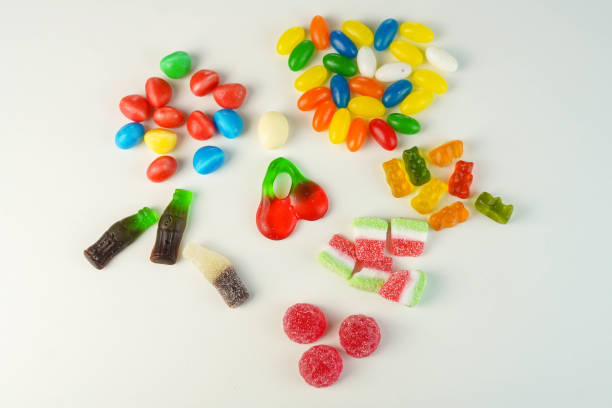 istock Many sweets and candies on a white background. Too much sugar concept 1316421786