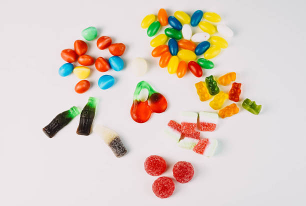 istock Many sweets and candies on a white background. Too much sugar concept 1316421803