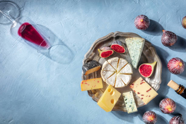 istock Cheese and wine background for a restaurant menu. Cheese platter with Brie 1316424064