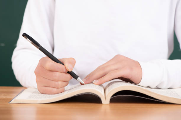 istock girl studying for exam in classroom text hard 1316424604