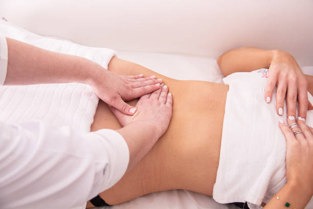 Massage, lymphatic drainage and aesthetic treatments. Woman doing massage, lymphatic drainage and beauty treatments in a spa clinic. drainage photos stock pictures, royalty-free photos & images