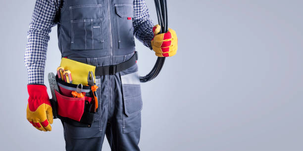 istock Electrician in uniform with wires and tools on  grey background with copy space. Banner. 1316427392