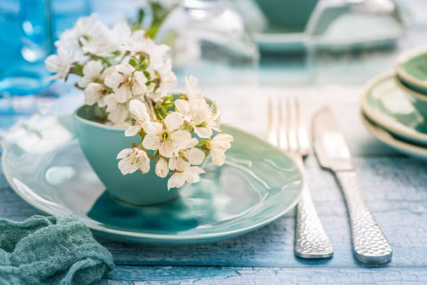 istock Place setting with blooming cherry branch in maritime blue style 1316428247