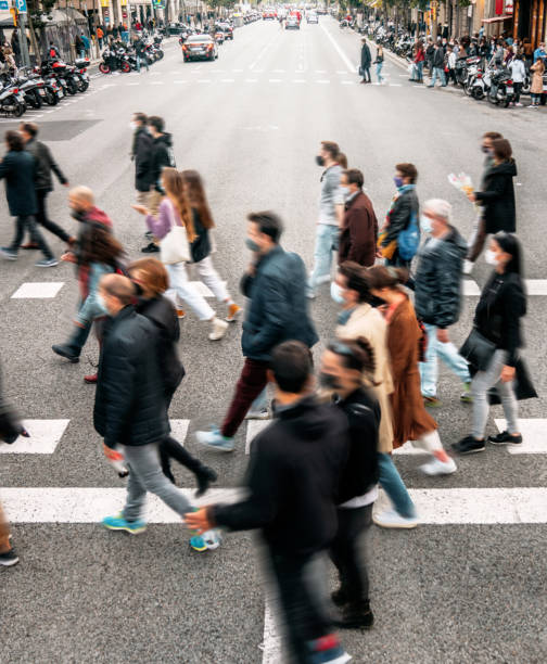 istock People wearing masks walking on zebra crossing 1316429449