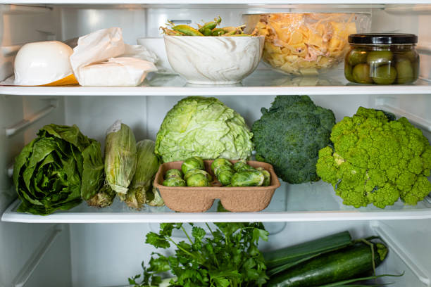istock Sustainable shopping and zero waste concept in home kitchen fridge with green vegetables. Healthy lifestyle and eco concept 1316430755