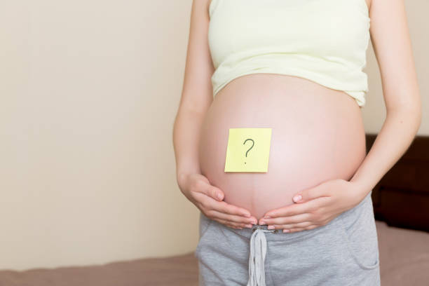 istock Pregnant woman belly with question mark. Pregnancy and thinking problem 1316432173